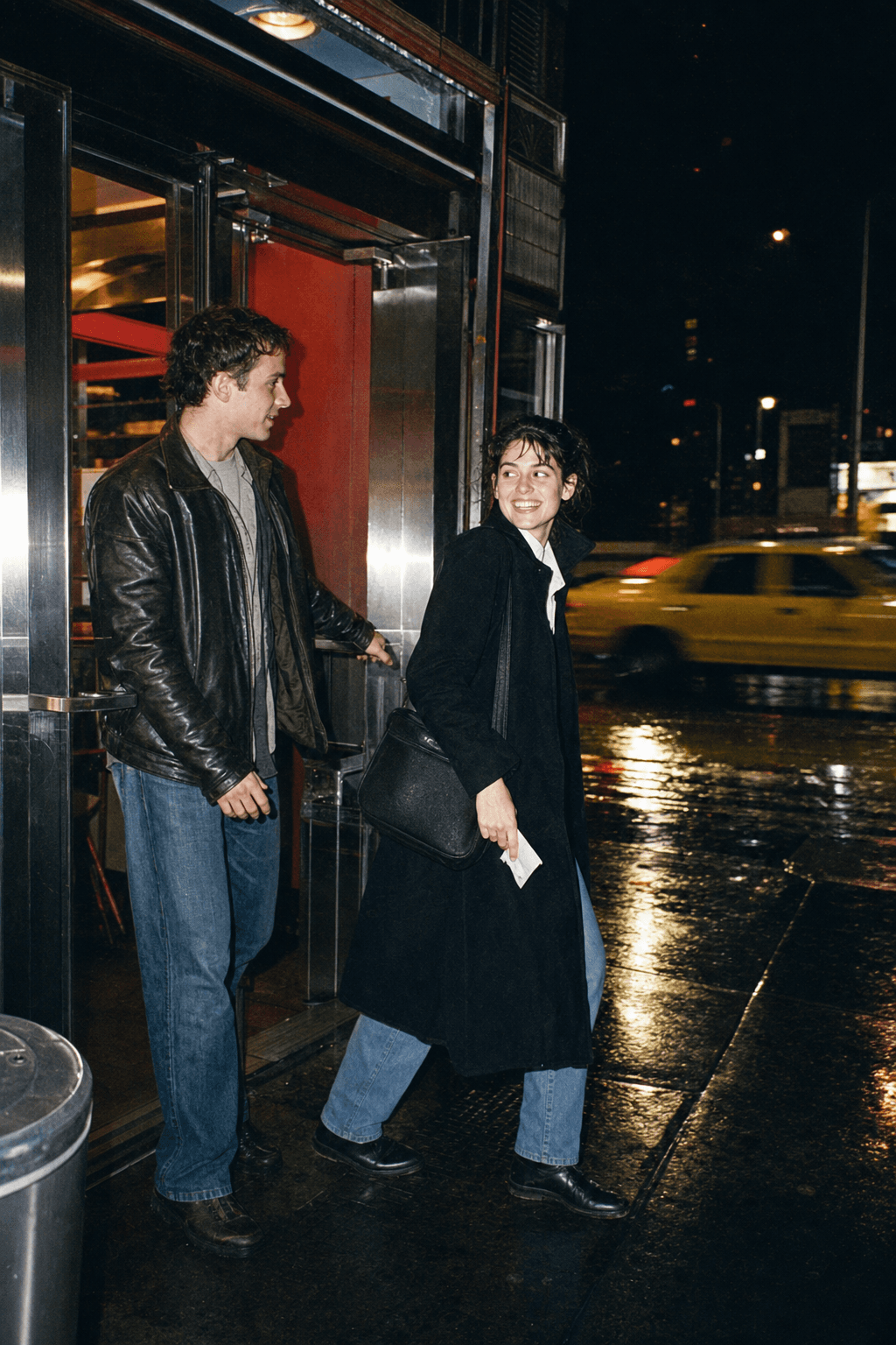 Two friends leaving a diner on a rainy New York night
