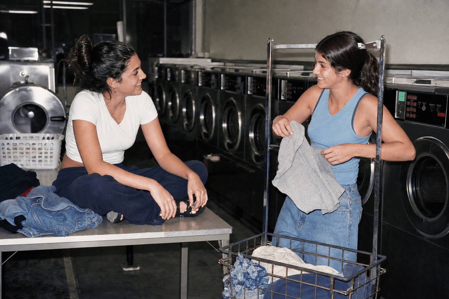Two friends talking in a neighborhood laundromat