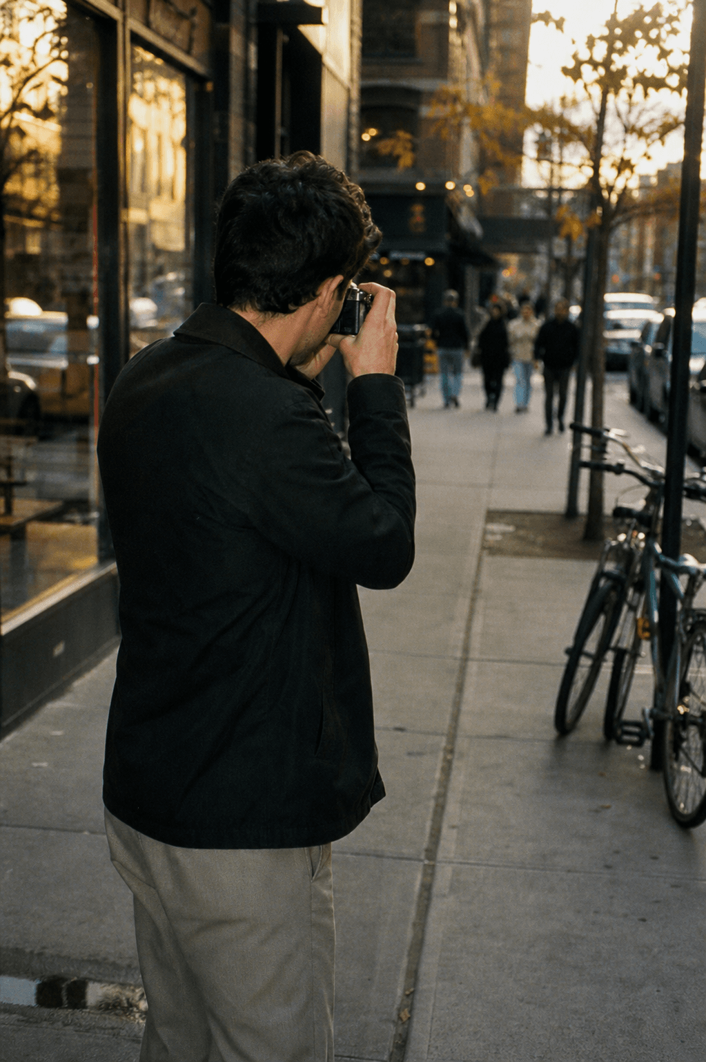 Jimmy photographing on a New York sidewalk
